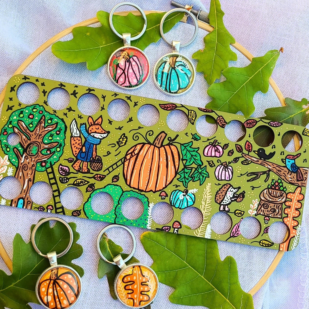 illustration of woodland animals collecting apples and berries and acorns with large pumpkin on wooden thread organiser