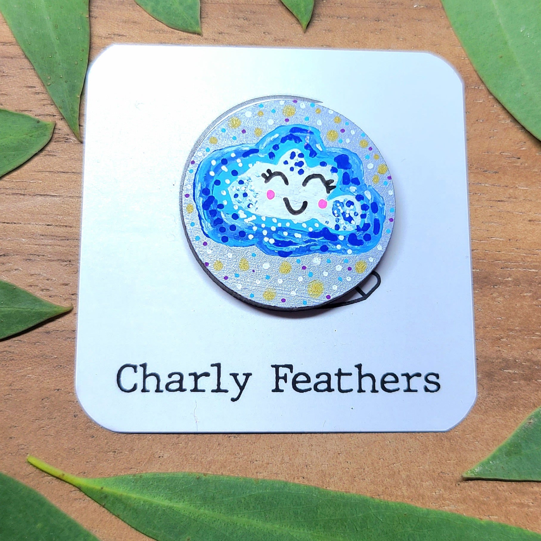illustration of cloud with happy face on silver needle minder