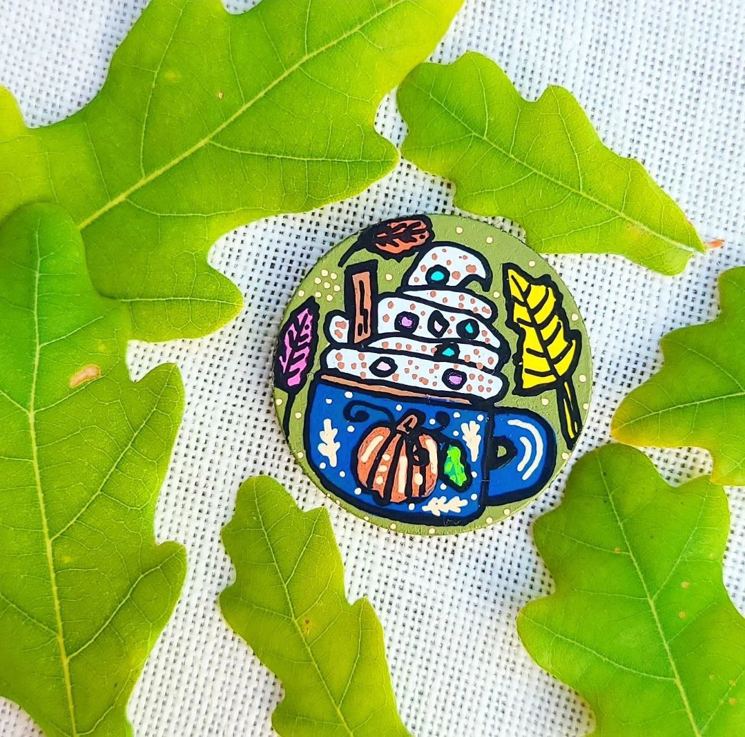 hand painted illustration of pumpkin spice hot chocolate with whipped cream on needle minder