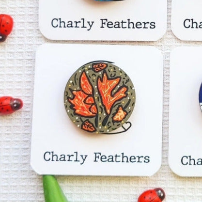 needle minder with autumn leaf design on a 'Charly Feathers' card.
