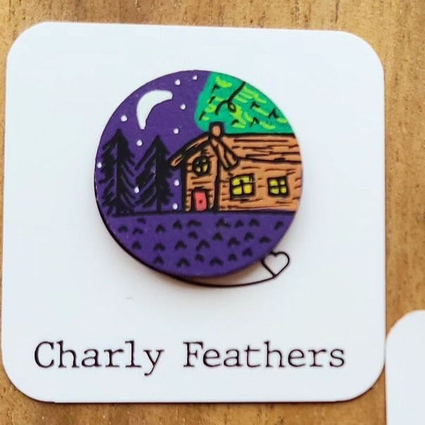 illustration of cabin at night on small needle minder