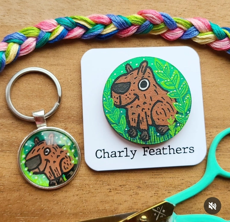 illustration of capybara on key ring and needle minder