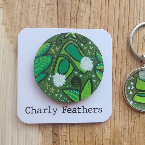 fair slippers on large green needleminder