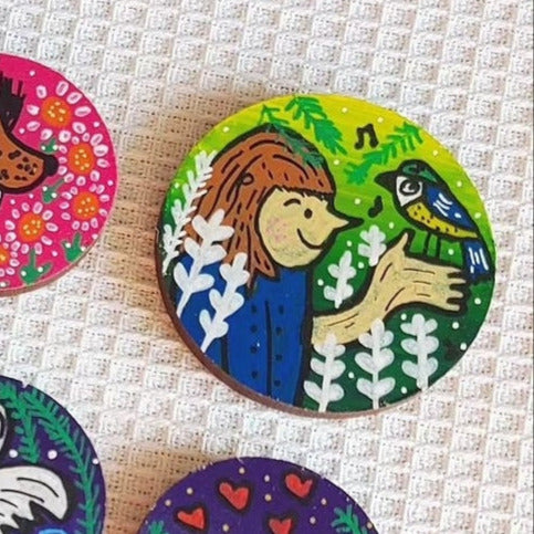 illustration of girl holding blue tit on small needle minder