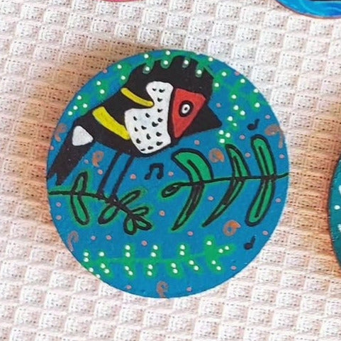 illustration of goldfinch on blue needle minder