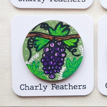 illustration of purple grapes on large needle minder