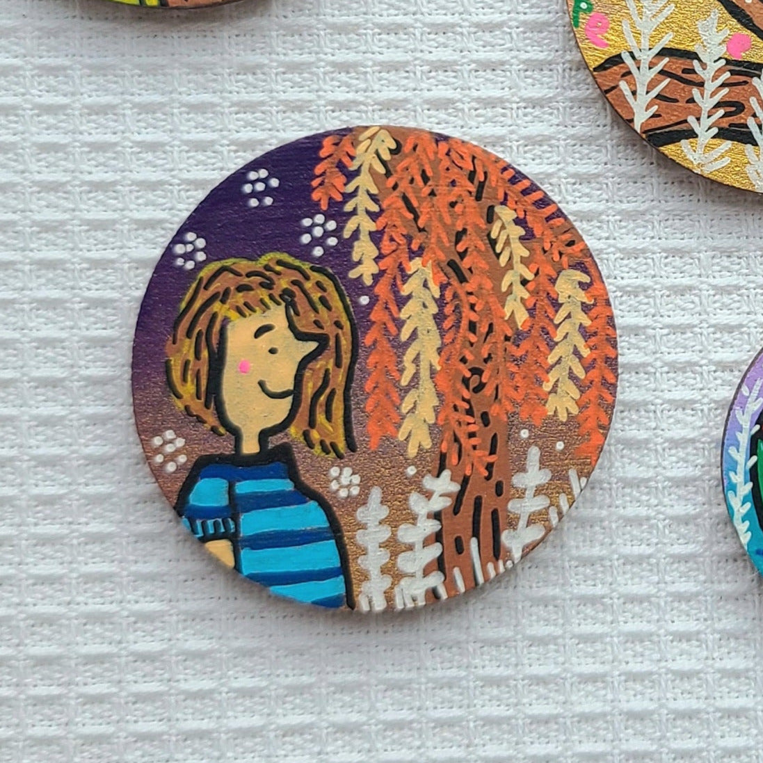 illustration of lady and willow tree on needle minder