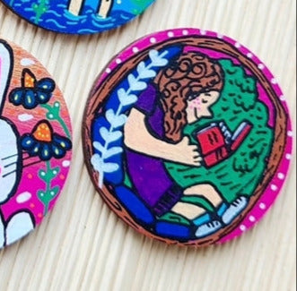 illustration of girl reading a book on large needle minder