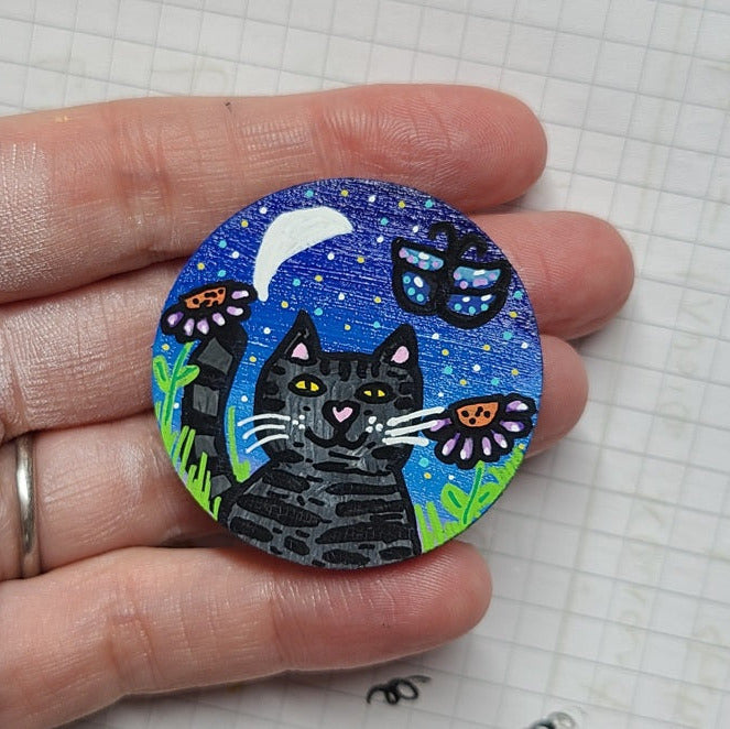 illustration of cat and butterfly at night under moon on large needle minder
