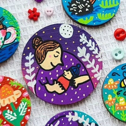 illustration of mum and baby on needle minder
