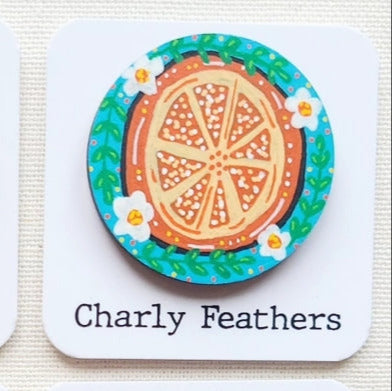 orange illustration on large needle minder