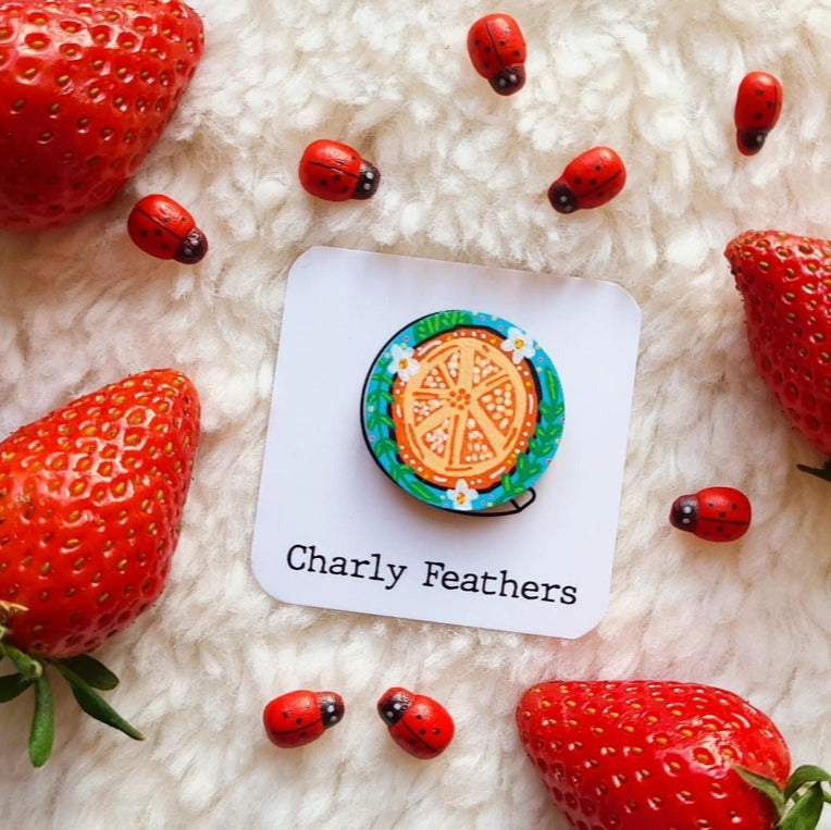 orange illustration on small needle minder