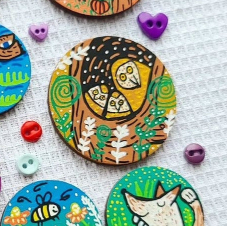 illustration of owl family in tree on needle minder
