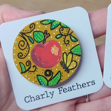 illustration of apple on ochre needle minder