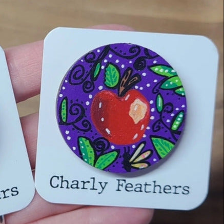 illustration of apple on purple needle minder