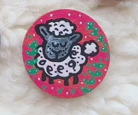 needle minder with a cartoon sheep design on a pink background