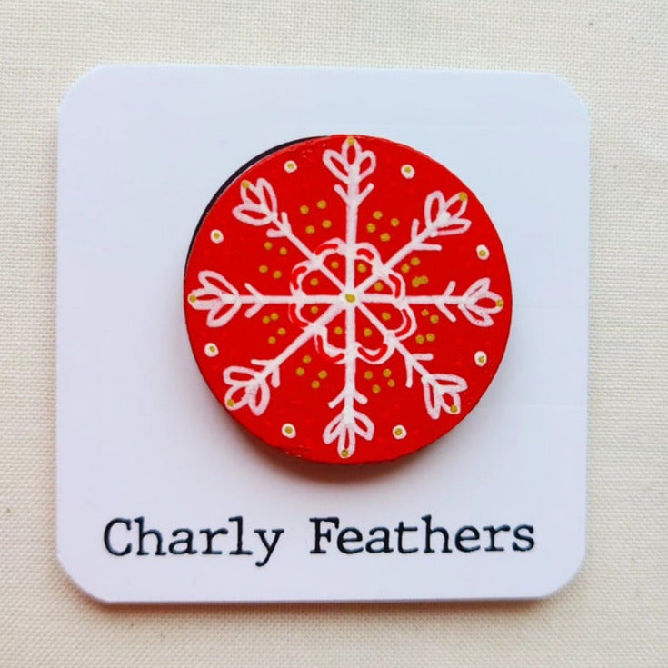 snowflake drawing on small needle minder