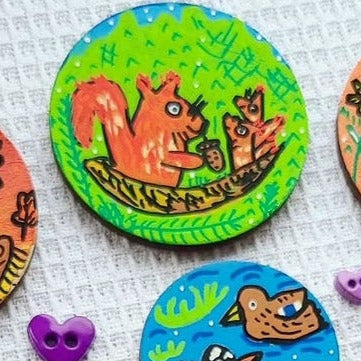 illustration of squirrel family on needle minder