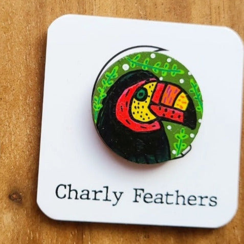 illustration of toucan on small needle minder