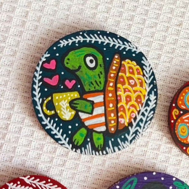 illustration of turtle drinking from mug on needle minder