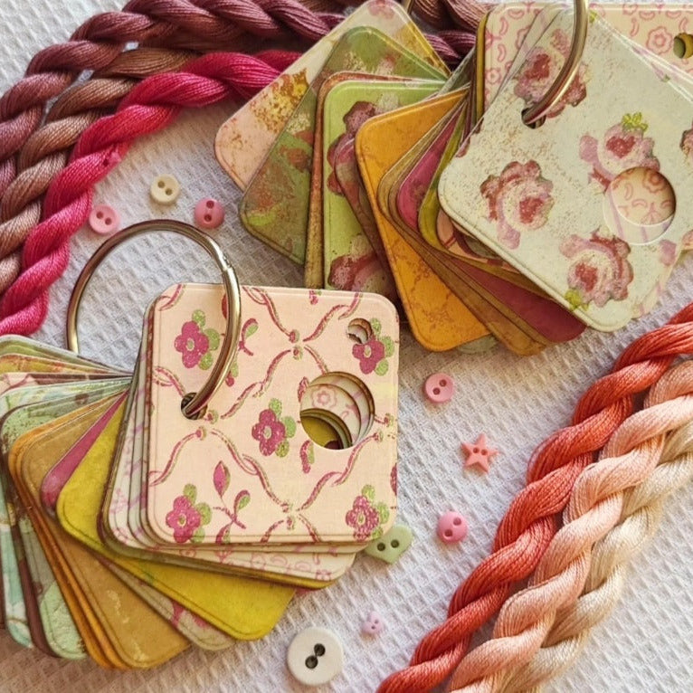 Color swatches with floral patterns and braided yarn on a textured surface