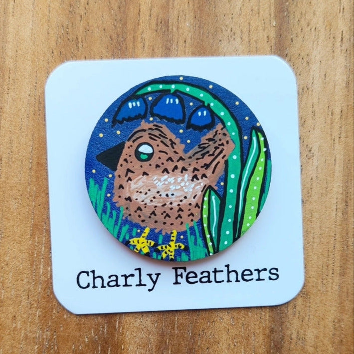 illustration of wren on large needle minder with Charly Feathers branding