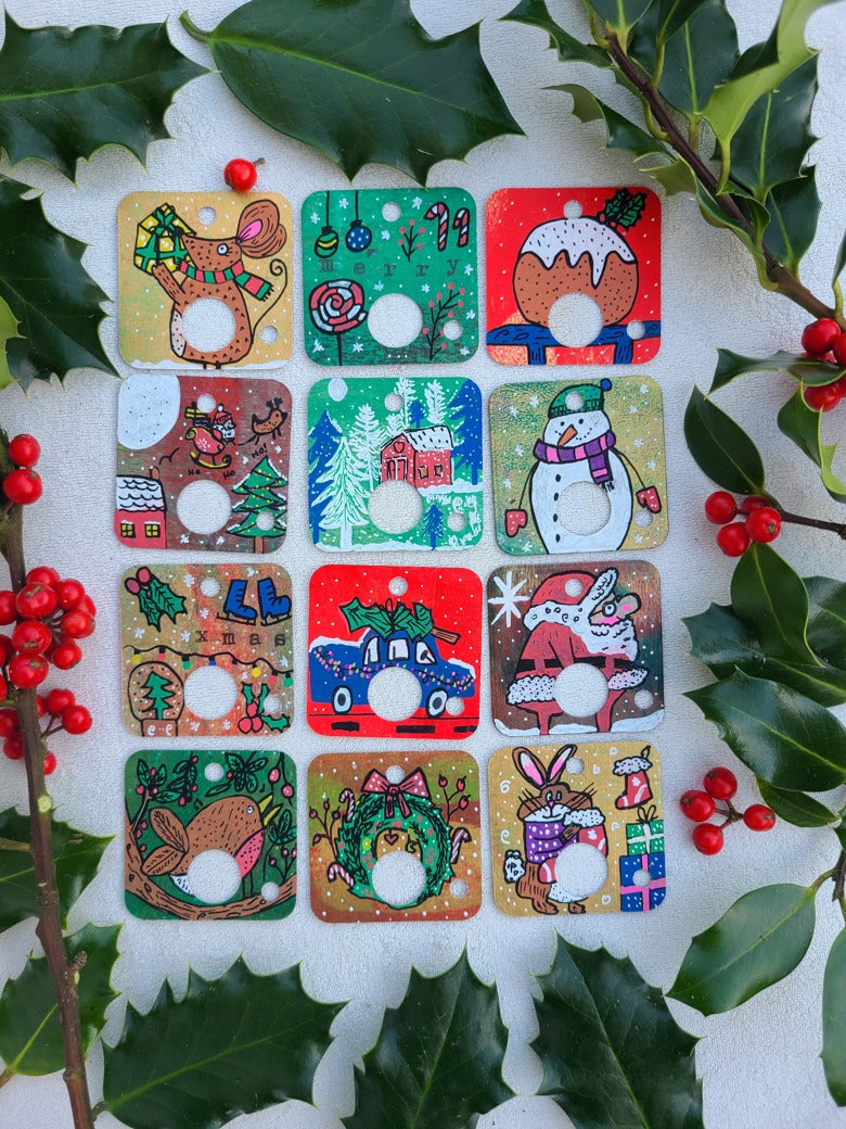 Set of Christmas-themed decorative tags with holly leaves and berries on a white background